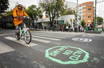 A woman rides a bike in Mexico City.