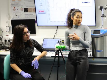 Project leaders Carmen Salvadores (left) and Shireen Jaufuraully (right) work with the sensorized glove.