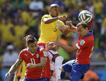 Fernandinho salta entre Marcelo Díaz y Eduardo Vargas.