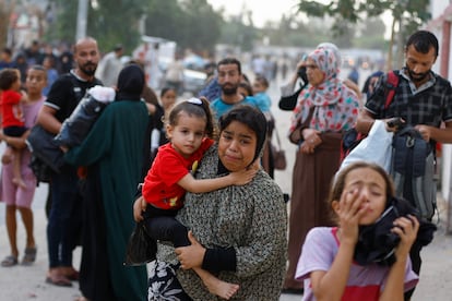 A group of people leave their homes in Khan Younis after an Israeli bombardment on the Gaza Strip, on October 9.