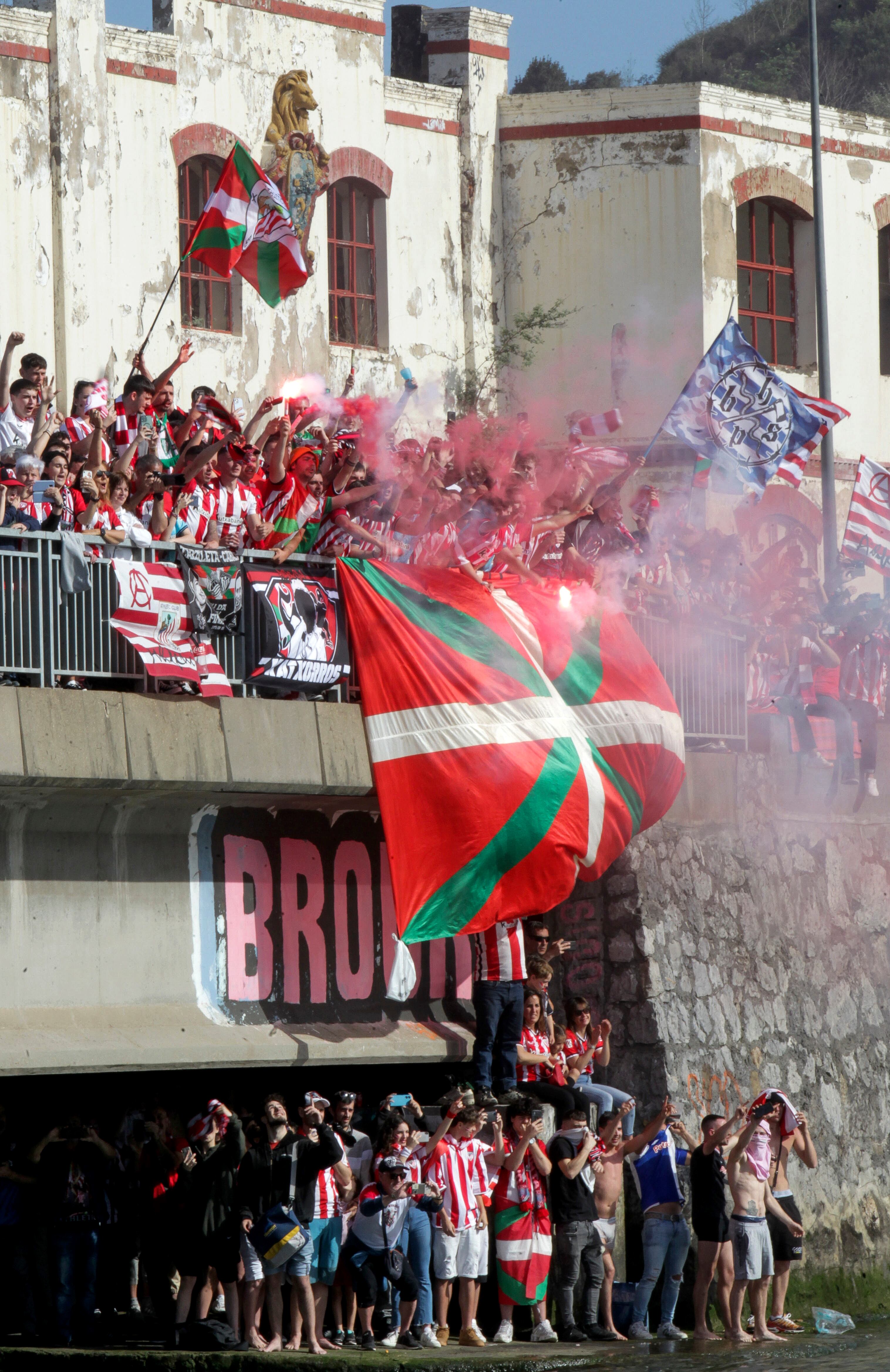 Seguidores del Athletic Club se congregan a lo largo de la ría para seguir a los jugadores. 