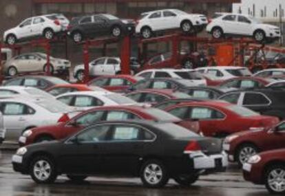 File of newly built cars sit in a shipping lot near General Motors Car assembly plant in Oshawa