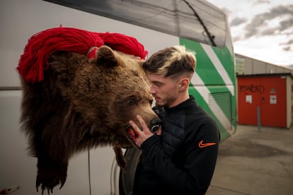 A member of the Sipoteni bear pack loads his costume on a bus, in Comanesti, northern Romania, Tuesday, Dec. 26, 2023, before touring villages in the area to perform the bear dance ritual.