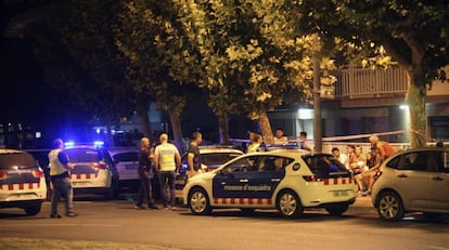 Police inspect the area where the suspects were killed.