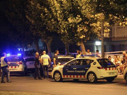 Police inspect the area where the suspects were killed.