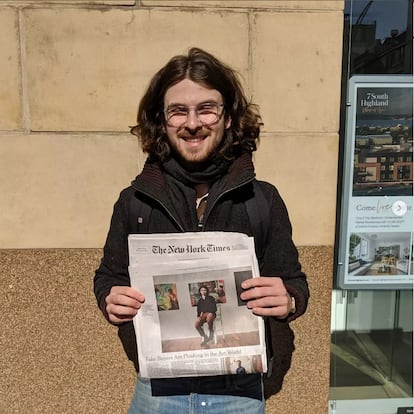 New York artist Zachary Ginsberg was scammed by a supposed collector out of $3,400. In this image, Ginsberg poses with 'The New York Times' article that tells his story.