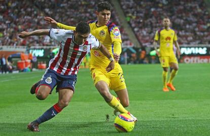 Pineda le gana el balón a Vargas durante el clásico.