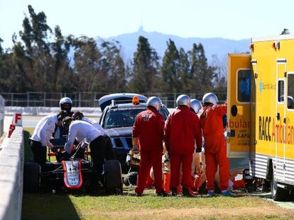Fernando Alonso receives medical assistance after Sunday’s crash.
