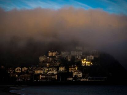 Una densa niebla cubre la playa de Ondarreta de San Sebastián.