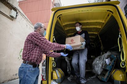 Voluntarios de Càritas descargan una furgoneta de alimentos.