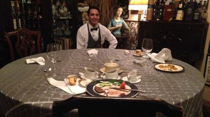 Mely at the table where the Obamas had dined an hour before.