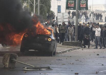 Un vehículo arde durante los choques entre la policía y los manifestantes en las cercanías del cementerio donde fue enterrado el líder opositor Belaid.