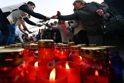 Personas dejando flores y velas en honor a las víctimas en el centro de Moscú.