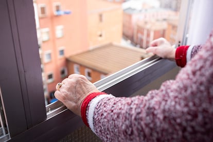 old woman leaning out the window