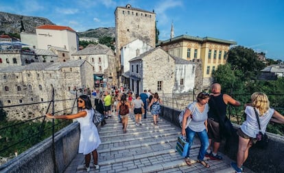 Visitantes sobre el puente de la ciudad vieja de Mostar.