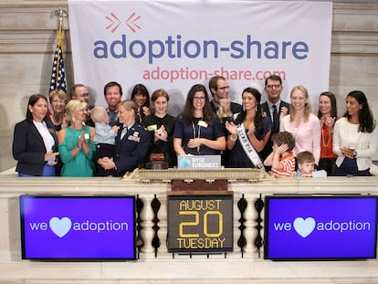 Adoption-Share founder and CEO Thea Ramirez, center, and fellow adoption supporters ring the opening bell at the New York Stock Exchange in New York on Aug. 20, 2013.