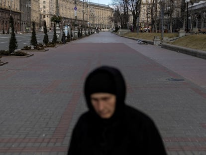 A woman walks in Kyiv after Russia’s massive military operation against Ukraine.