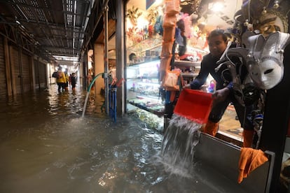 Um vendedor retira água de sua loja em Veneza (Itália), no dia 29 de outubro de 2018. Seis regiões italianas estão em alerta vermelho pelo forte temporal e as intensas chuvas que estão açoitando o país nos últimos dias.