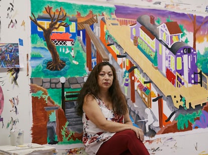 Lady Pink, in her workshop with some of her art.