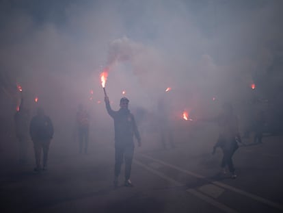 Protesters march with flares during a demonstration in Marseille, southern France