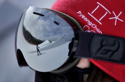 Un voluntario observa el entrenamiento de algunas atletas durante la prueba de slopestyle femenino, el 11 de febrero de 2018.