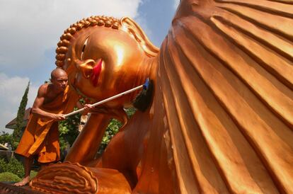 El mundo budista se preprara para la conmemoración de la iluminación, nacimiento y muerte de Buda que se celebra el 2 de junio. En la imagen, un monje limpia una enorme estatua en un templo de Malang en la isla de Java, Indonesia.