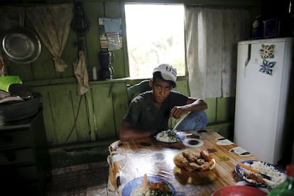 Roque sits at the table inside his house in the village of Rio Pardo next to Bom Futuro National Forest, in the district of Porto Velho, Rondonia State, Brazil, September 1, 2015. The town of Rio Pardo, a settlement of about 4,000 people in the Amazon rainforest, rises where only jungle stood less than a quarter of a century ago. Loggers first cleared the forest followed by ranchers and farmers, then small merchants and prospectors. Brazil's government has stated a goal of eliminating illegal deforestation, but enforcing the law in remote corners like Rio Pardo is far from easy. REUTERS/Nacho Doce PICTURE 18 OF 40 FOR WIDER IMAGE STORY "EARTHPRINTS: RIO PARDO" SEARCH"EARTHPRINTS PARDO" FOR ALL IMAGES