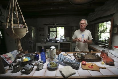 Chris in the kitchen he built at El Valero. For many years he lacked enough electricity to power a fridge or freezer. He says he loves cooking.