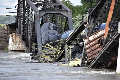 Several train cars are immersed in the Yellowstone River after a bridge collapse near Columbus, Mont., on Saturday, June 24, 2023.