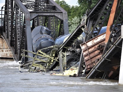 Several train cars are immersed in the Yellowstone River after a bridge collapse near Columbus, Mont., on Saturday, June 24, 2023.