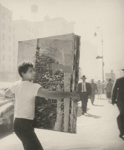 Alfred Leslie trasladando una pintura en la Cuarta Avenida, 1959