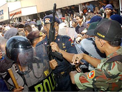 La policía indonesia trata de controlar a la multitud congreda ante el hospital de Solo.