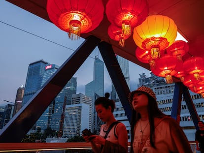 Red lanterns are seen hanging on the pedestrian footbridge as decorations for the celebration of National Day, in the financial central district of Hong Kong, China October 3, 2023.