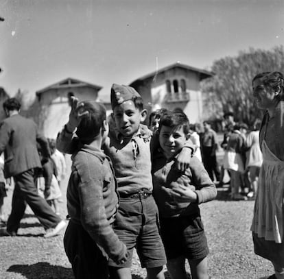 Tres niños delante de un palacio convertido en escuela, en 1937.