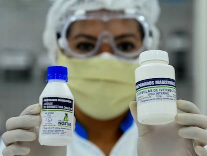 A health worker holds two bottles of ivermectin in Santa Cruz de la Sierra, Bolivia.