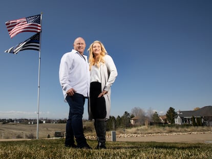 Jennifer and Tim Kohl poses for a photo in their front yard with the American flag and a thin blue line flag in Star, Idaho, on April 14, 2023.