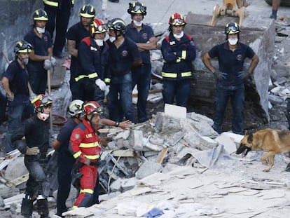 Fire crews search the rubble for survivors.