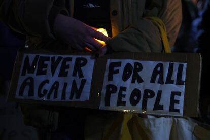 A woman carrying a sign attends a candlelight vigil for three college students of Palestinian descent who were shot over the weekend in Burlington near the University of Vermont, in Brattleboro, Vermont, U.S., November 27, 2023