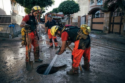 Un equipo de bomberos trabaja para desatascar unas cañerías en Picanya (Valencia).