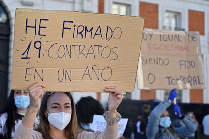 A healthcare worker holds a sign reading “I signed 19 contracts in one year” at a protest in Puerta del Sol in Madrid on Spain’s National Day, October 12.
