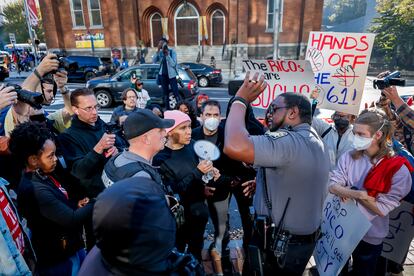 Fulton County Sheriff's deputies speak to organizers, as 'Stop Cop City' demonstrators protest outside the Fulton County Courthouse