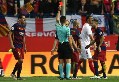 El árbitro Del Cerro Grande muestra tarjeta roja al argentino Javier Mascherano, del FC Barcelona.