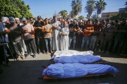 Familiares de varias víctimas de los ataques israelíes en Deir al-Balah asisten a su funeral este lunes en Gaza.