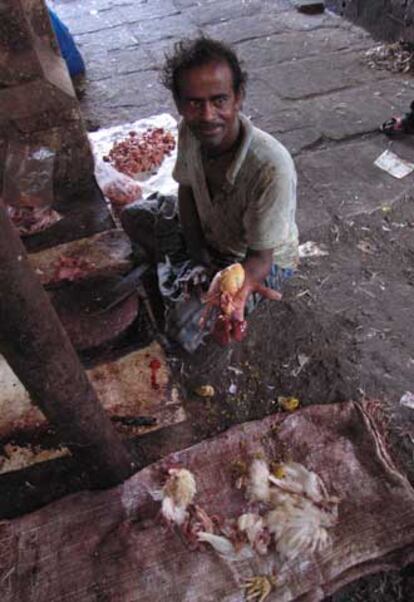 Abdul Rashid muestra un hígado de pollo en el mercado Crawford en Bombay.