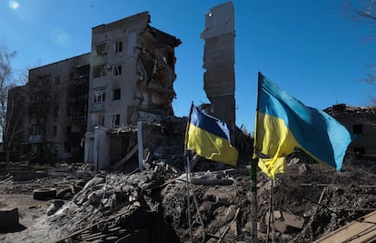 Ukrainian flags wave in front of damaged residential buildings in Orikhiv, near the frontline in the Zaporizhzhia region