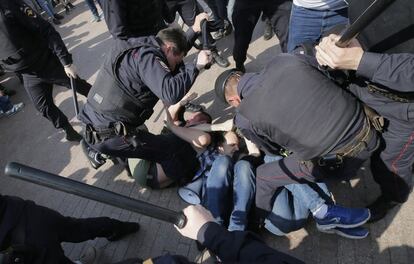 Varios agentes de la policía golpean a varios manifestantes durante una protesta contra Vladimir Putin en el centro de Moscú (Rusia).