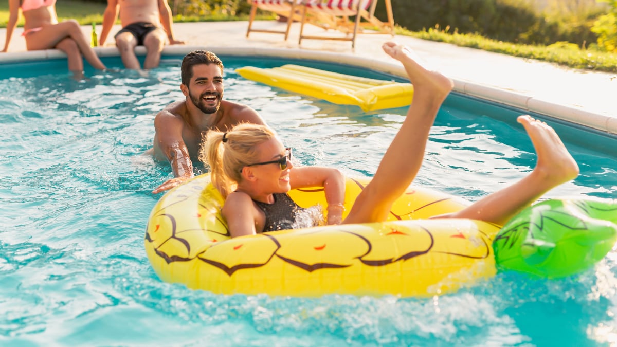 Couple having fun at a poolside party.