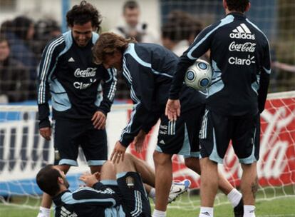 Los futbolistas de Argentina, Carlos Tévez, Gabriel Heinze y Maxi Rodríguez, juegan con Javier Mascherano durante el entrenamiento de su equipo.