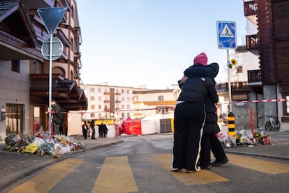 Two people hugging each other near the area where a fire broke out at the Le Constellation bar and lounge leaving people dead and injured, during New Years celebration, in Crans-Montana, Swiss Alps, Switzerland