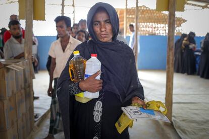 Una rohinyá recoge en un centro de distribución de comida del Programa Mundial de los Alimentos la ración mensual de su familia.